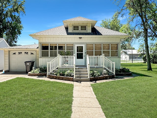 3018 Linden Ave, Slayton, MN 56172 - view of front facade featuring a shingled roof, a garage, board and batten siding, a front lawn, and a porch
