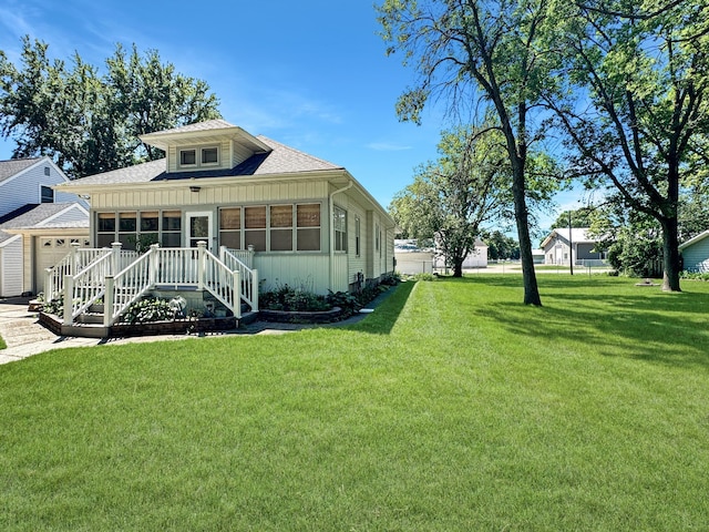 3018 Linden Ave, Slayton, MN 56172 - back of property with a garage, a lawn, roof with shingles, and board and batten siding