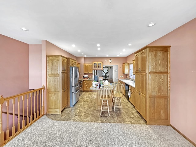 3018 Linden Ave, Slayton, MN 56172 - kitchen featuring dishwasher, stainless steel fridge, recessed lighting, light colored carpet, and a breakfast bar