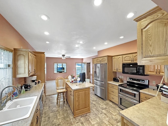 3018 Linden Ave, Slayton, MN 56172 - kitchen featuring stainless steel appliances, a kitchen island, light countertops, a ceiling fan, and recessed lighting