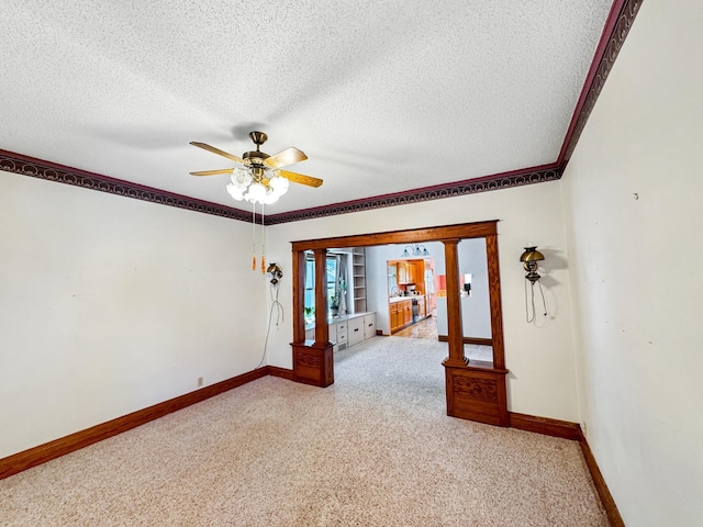3018 Linden Ave, Slayton, MN 56172 - spare room with light carpet, a textured ceiling, a ceiling fan, and ornamental molding