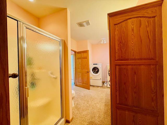 3018 Linden Ave, Slayton, MN 56172 - bathroom with washer / dryer and a shower stall