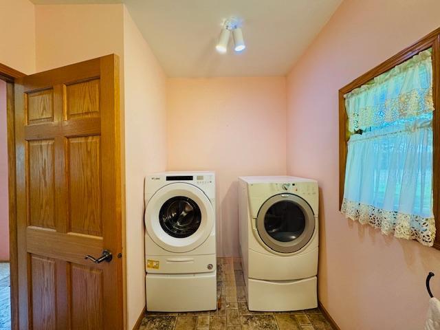 3018 Linden Ave, Slayton, MN 56172 - washroom featuring washer and dryer and stone finish floors