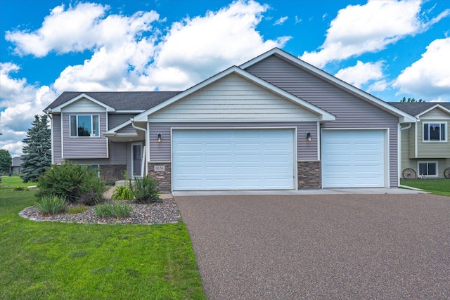 8638 Preserve Blvd N, Chisago City, MN 55013 - view of front of house featuring a garage, stone siding, driveway, and a front yard