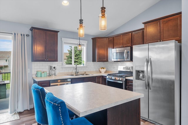 8638 Preserve Blvd N, Chisago City, MN 55013 - kitchen with stainless steel appliances, vaulted ceiling, light wood finished floors, backsplash, and light countertops