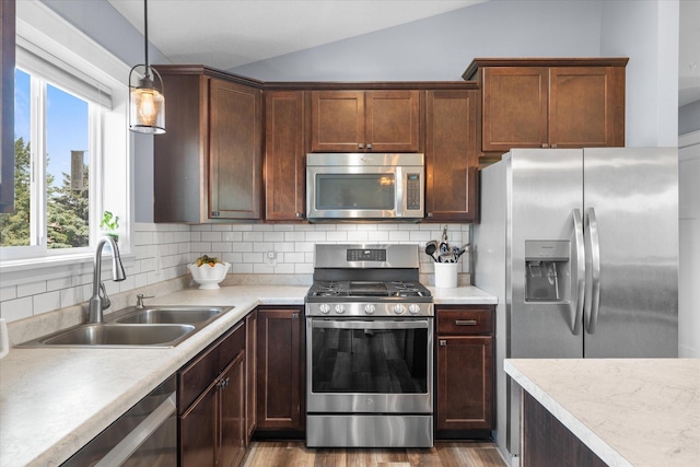 8638 Preserve Blvd N, Chisago City, MN 55013 - kitchen featuring appliances with stainless steel finishes, vaulted ceiling, light countertops, backsplash, and plenty of natural light