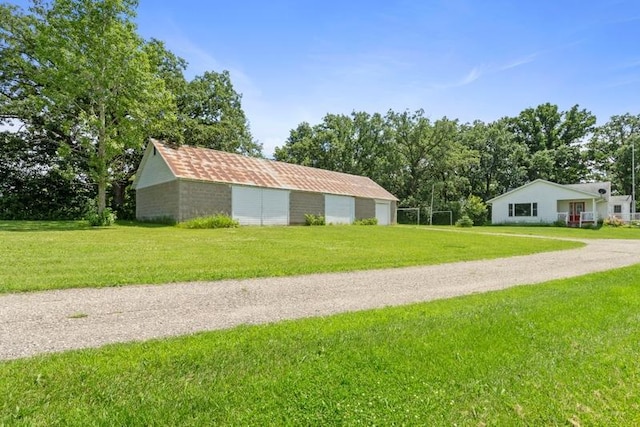 322 Central Ave N, Eagle Bend, MN 56446 - view of green lawn with a detached garage and view of scattered trees