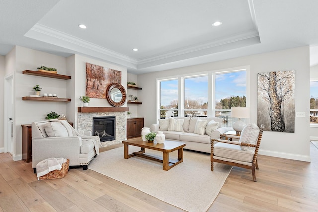 3886 Larabee Ave NE, Saint Michael, MN 55376 - living area with a tray ceiling, light wood finished floors, ornamental molding, a glass covered fireplace, and recessed lighting