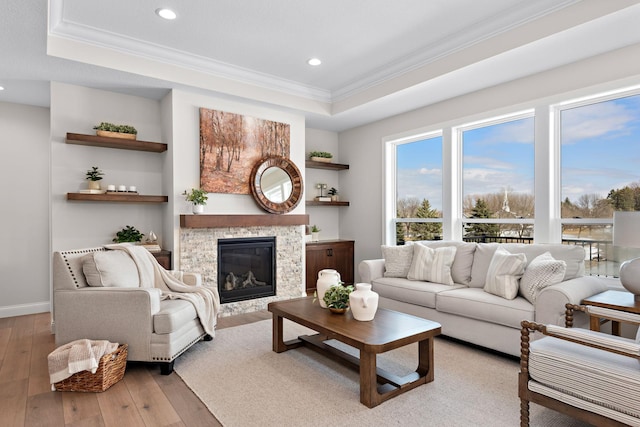3886 Larabee Ave NE, Saint Michael, MN 55376 - living room with ornamental molding, a tray ceiling, hardwood / wood-style floors, a glass covered fireplace, and recessed lighting