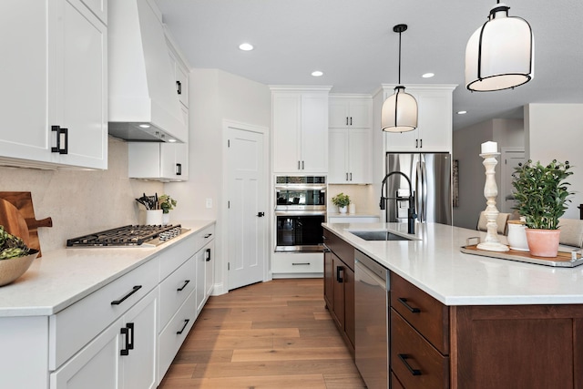 3886 Larabee Ave NE, Saint Michael, MN 55376 - kitchen featuring custom range hood, appliances with stainless steel finishes, light wood-type flooring, tasteful backsplash, and recessed lighting