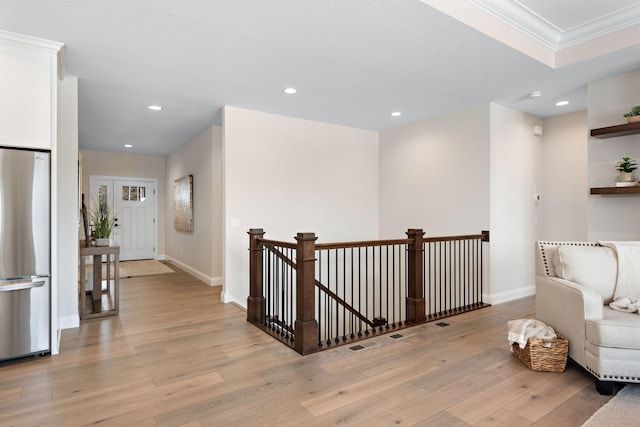 3886 Larabee Ave NE, Saint Michael, MN 55376 - sitting room with recessed lighting, light wood-type flooring, ornamental molding, and an upstairs landing