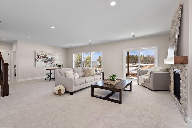 3886 Larabee Ave NE, Saint Michael, MN 55376 - living area with light carpet, a glass covered fireplace, recessed lighting, and stairs