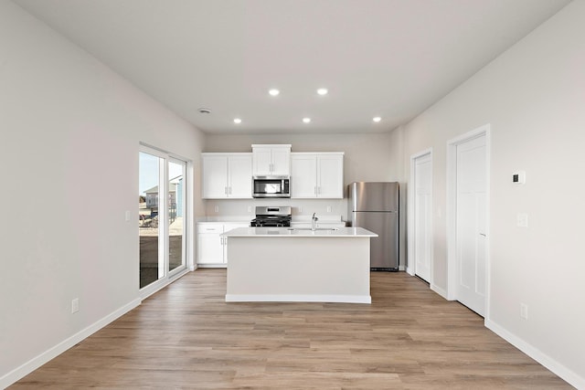 39749 Fallbrook Ave, North Branch, MN 55056 - kitchen with stainless steel appliances, recessed lighting, white cabinetry, light wood-style flooring, and light countertops