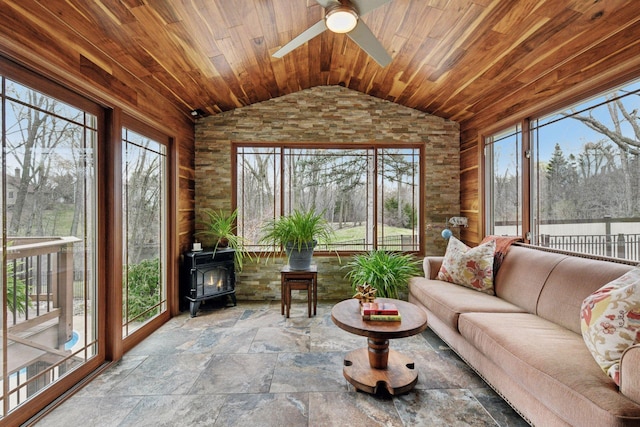 3600 Wedgewood Ln N, Plymouth, MN 55441 - sunroom featuring lofted ceiling, wooden ceiling, a wood stove, stone finish floors, and healthy amount of natural light