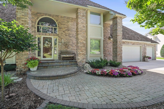 3600 Wedgewood Ln N, Plymouth, MN 55441 - doorway to property with an attached garage, brick siding, and driveway