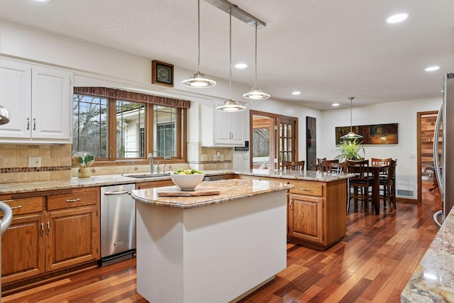 3600 Wedgewood Ln N, Plymouth, MN 55441 - kitchen with a kitchen island, stainless steel dishwasher, recessed lighting, backsplash, and dark wood-style flooring