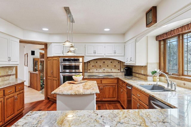 3600 Wedgewood Ln N, Plymouth, MN 55441 - kitchen featuring appliances with stainless steel finishes, dark wood finished floors, light stone countertops, decorative light fixtures, and backsplash