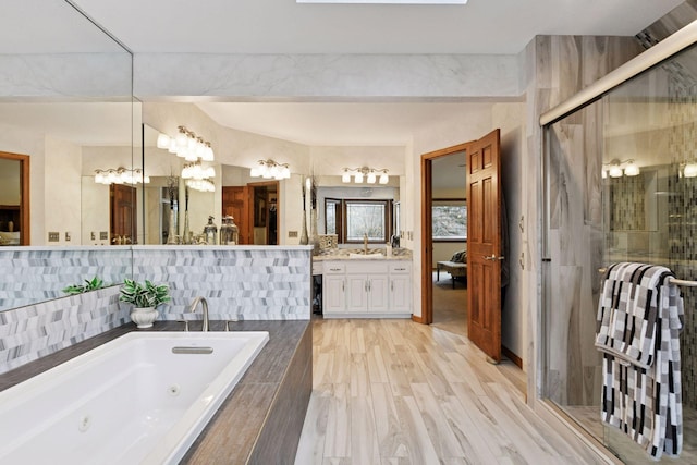 3600 Wedgewood Ln N, Plymouth, MN 55441 - bathroom with a whirlpool tub, vanity, and a shower stall