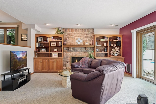3600 Wedgewood Ln N, Plymouth, MN 55441 - living room featuring light colored carpet, healthy amount of natural light, a fireplace, and a textured ceiling
