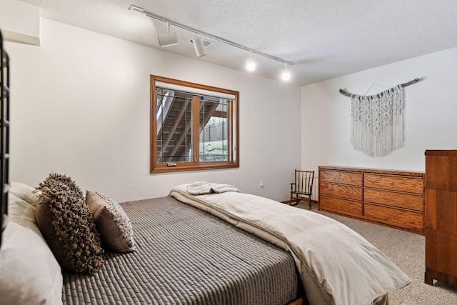3600 Wedgewood Ln N, Plymouth, MN 55441 - bedroom with carpet, track lighting, and a textured ceiling