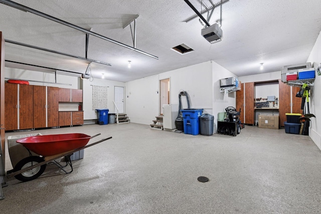 3600 Wedgewood Ln N, Plymouth, MN 55441 - garage featuring a garage door opener and a wall mounted AC