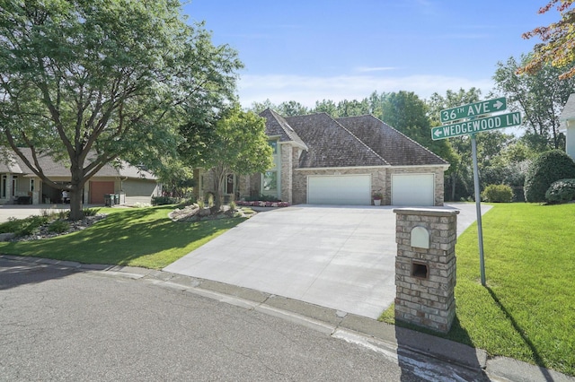 3600 Wedgewood Ln N, Plymouth, MN 55441 - view of front facade featuring a front yard, driveway, an attached garage, and brick siding
