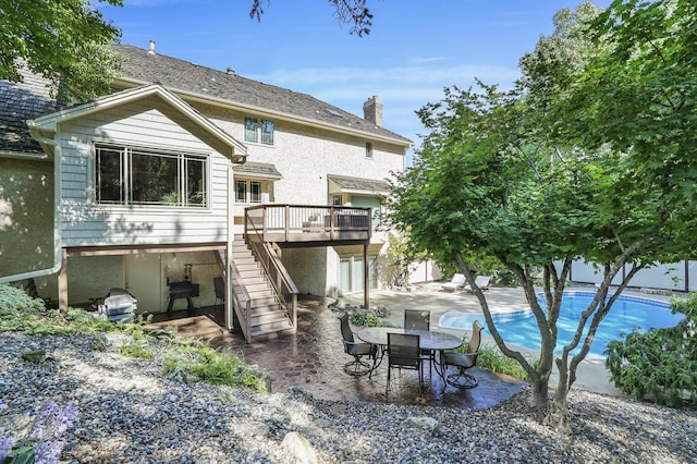 3600 Wedgewood Ln N, Plymouth, MN 55441 - back of property with stairs, a wooden deck, a patio, and a chimney