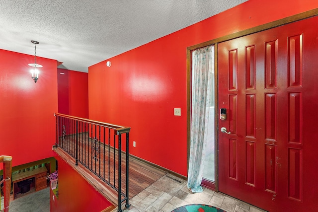 7609 James Ave N, Brooklyn Park, MN 55444 - foyer with a textured ceiling and baseboards