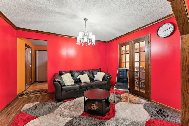 7609 James Ave N, Brooklyn Park, MN 55444 - living area with ornamental molding, a textured ceiling, wood finished floors, french doors, and a chandelier