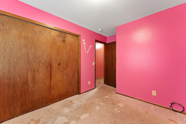 7609 James Ave N, Brooklyn Park, MN 55444 - unfurnished bedroom featuring a closet, carpet flooring, and a textured ceiling