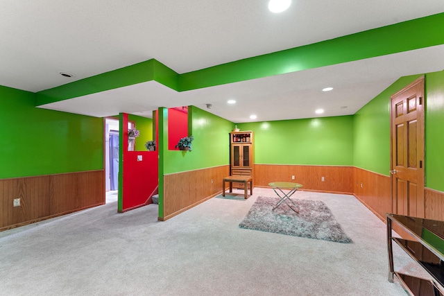 7609 James Ave N, Brooklyn Park, MN 55444 - living area with a wainscoted wall, wood walls, carpet, and recessed lighting