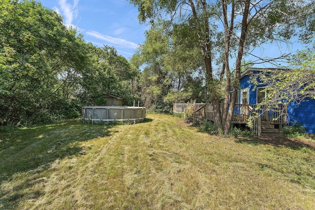 7609 James Ave N, Brooklyn Park, MN 55444 - view of green lawn featuring a deck and an outdoor pool