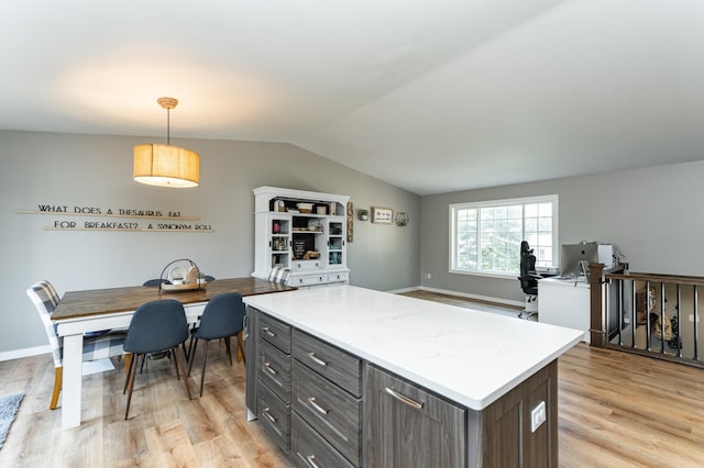 2 Lillie Ln SE, Pine Island, MN 55963 - kitchen featuring light wood-style flooring, lofted ceiling, a center island, light countertops, and pendant lighting