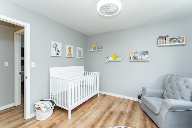 2 Lillie Ln SE, Pine Island, MN 55963 - bedroom featuring wood finished floors and a nursery area