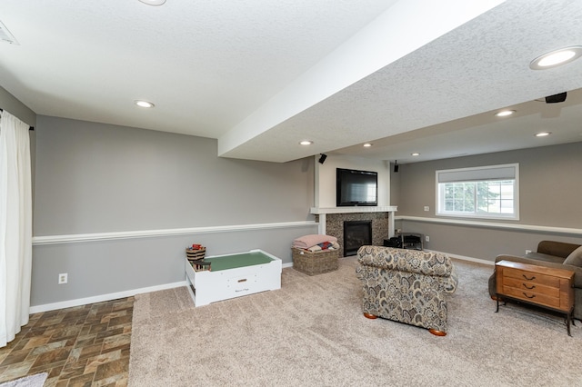 2 Lillie Ln SE, Pine Island, MN 55963 - carpeted living area with a glass covered fireplace, recessed lighting, and a textured ceiling
