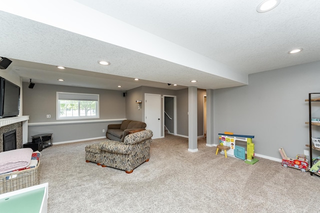 2 Lillie Ln SE, Pine Island, MN 55963 - living area featuring carpet flooring, a glass covered fireplace, a textured ceiling, and recessed lighting