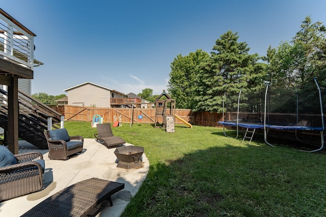 2 Lillie Ln SE, Pine Island, MN 55963 - fenced backyard with a trampoline, a playground, a patio, and stairway