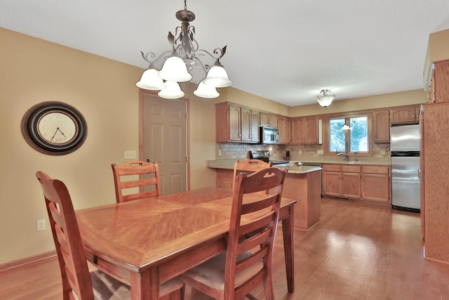 6 Pleasant View Ln, Circle Pines, MN 55014 - dining area featuring light wood finished floors and a chandelier