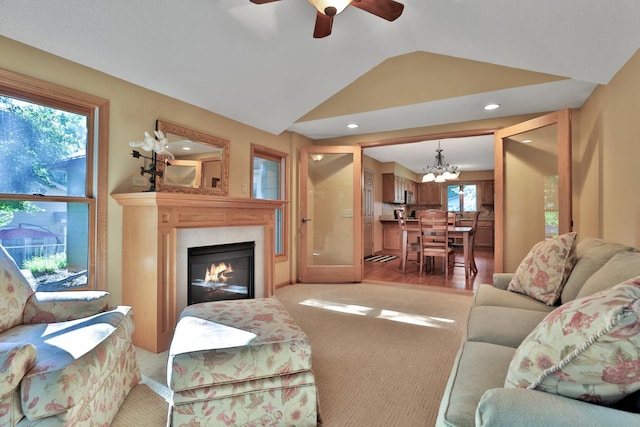 6 Pleasant View Ln, Circle Pines, MN 55014 - living area with lofted ceiling, a chandelier, light colored carpet, a glass covered fireplace, and a ceiling fan