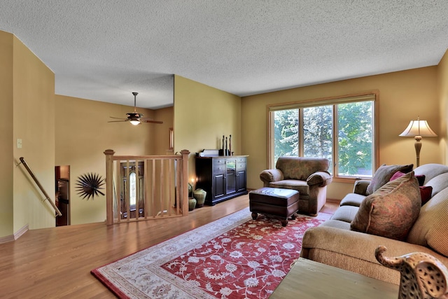 6 Pleasant View Ln, Circle Pines, MN 55014 - living room with wood finished floors, a ceiling fan, and a textured ceiling