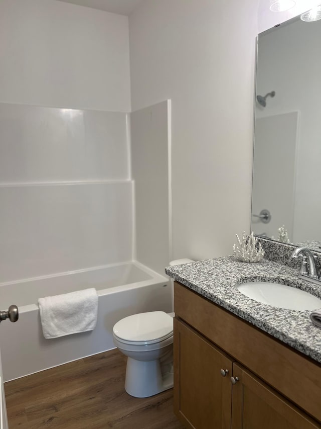 full bath featuring vanity, wood finished floors, and bathtub / shower combination