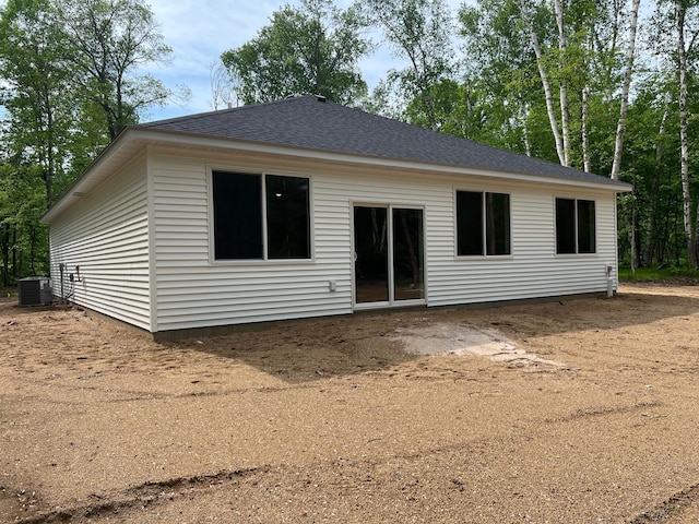 back of property featuring a shingled roof