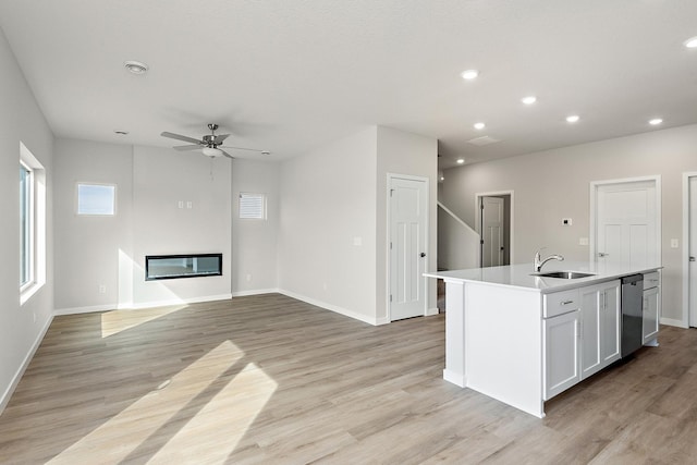 39730 Fallbrook Ave, North Branch, MN 55056 - kitchen featuring dishwasher, ceiling fan, light wood-type flooring, a kitchen island with sink, and light countertops
