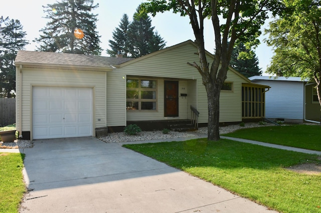 308 Maple Ave S, Thief River Falls, MN 56701 - view of front of property with a garage, a front yard, and driveway