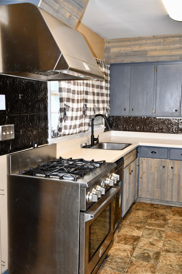 308 Maple Ave S, Thief River Falls, MN 56701 - kitchen with range with two ovens, ventilation hood, gray cabinetry, light countertops, and wooden walls