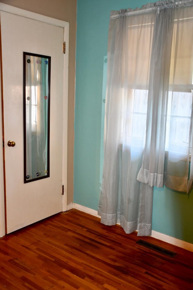 308 Maple Ave S, Thief River Falls, MN 56701 - spare room with wood finished floors and healthy amount of natural light