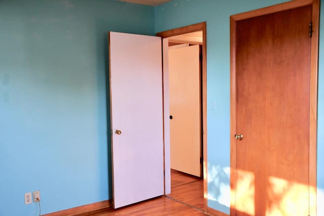 308 Maple Ave S, Thief River Falls, MN 56701 - unfurnished bedroom featuring wood finished floors