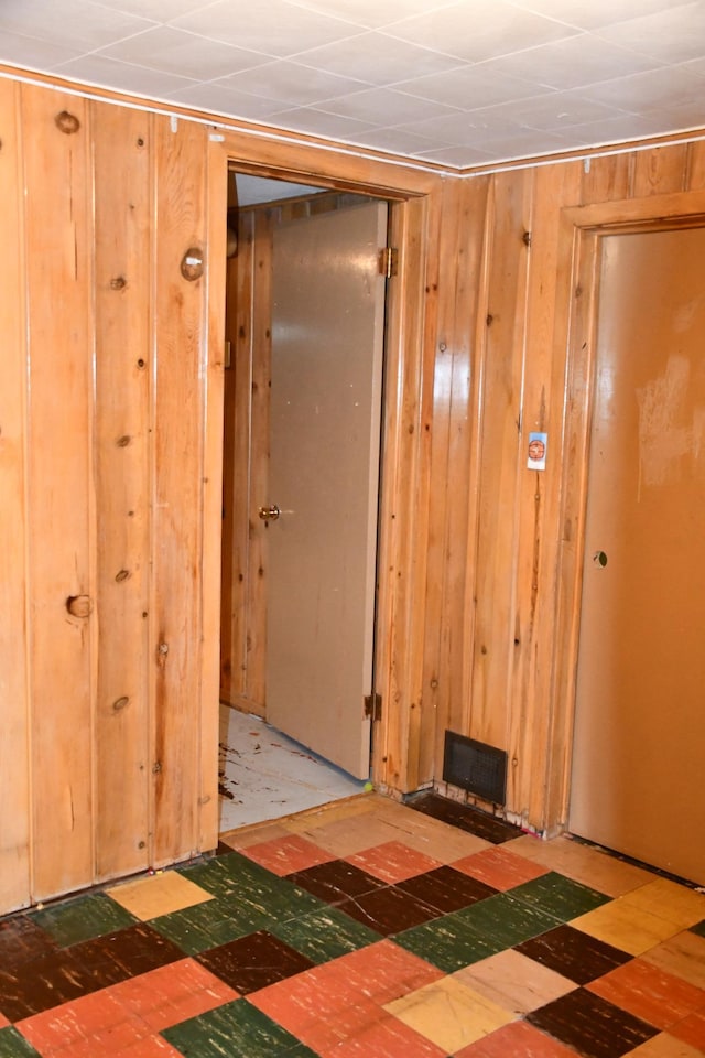 308 Maple Ave S, Thief River Falls, MN 56701 - hallway featuring wood walls and tile patterned floors
