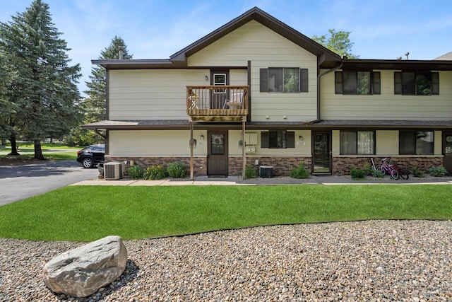 13525 Zenith Ln, Eden Prairie, MN 55346 - view of front of home with a balcony, brick siding, and a front yard