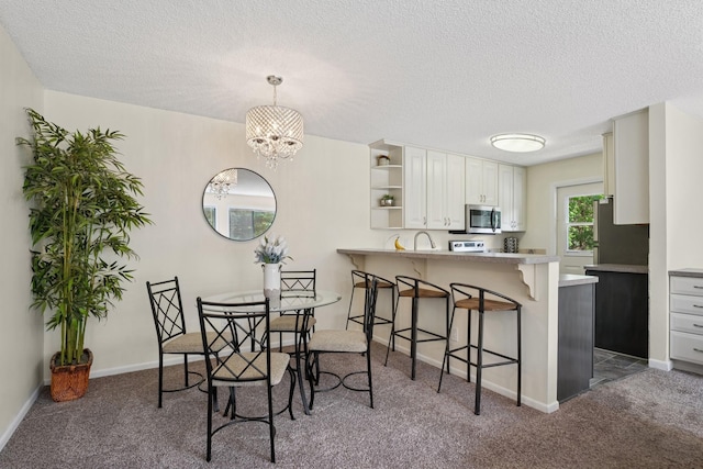 13525 Zenith Ln, Eden Prairie, MN 55346 - dining space with carpet floors, a textured ceiling, and a chandelier
